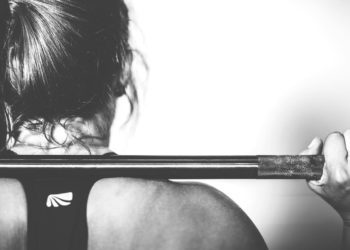 A fit woman pulls weights