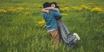 A couple in a green field