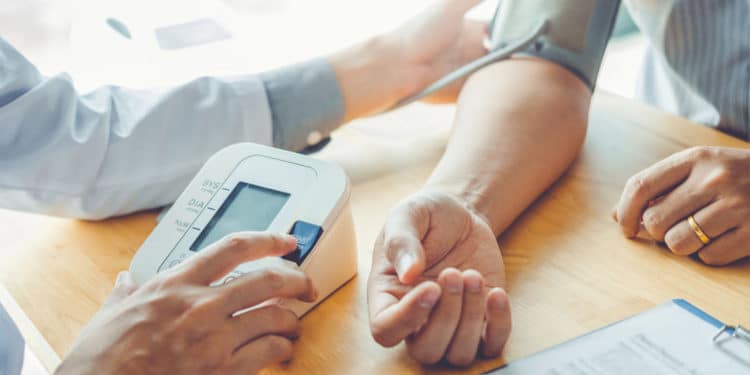 Doctor measuring arterial blood pressure on a man's arm Hospitalized health care