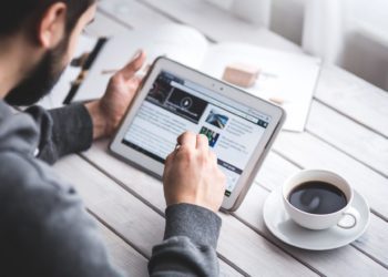 Man reading Healthy Lifestyle Blogs on his tablet.