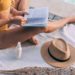 Woman in Yellow Bikini Wearing Brown Sun Hat Reading Book