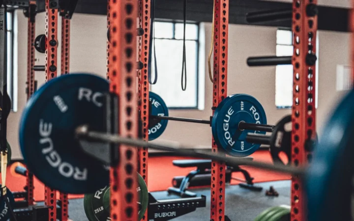 Close-up view of gym equipment with barbells and weight plates, perfect for strength training enthusiasts.
