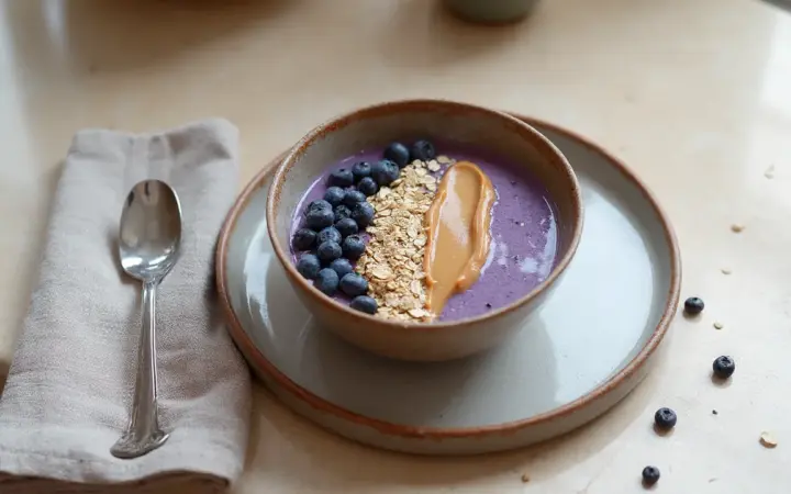 Generated illustration of blueberry protein smoothie bowl, not a photograph of the dish