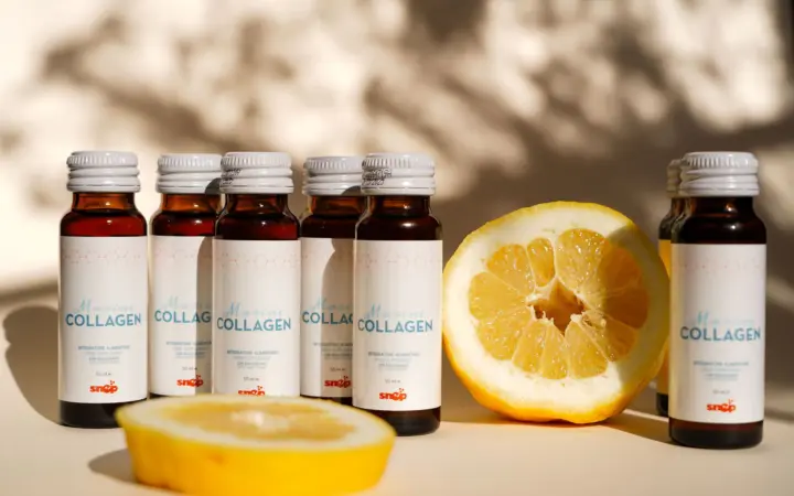 Collagen peptides for skin: collagen supplement bottles with lemon slice in bright light