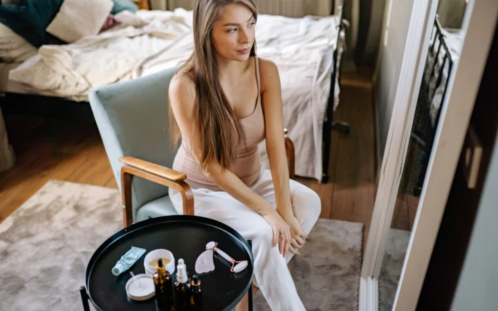 Pregnant woman enjoying her morning self-care routine with skincare products.