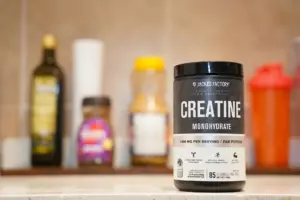 Does creatine cause hair loss: creatine monohydrate from Jacked Factory displayed on a kitchen counter