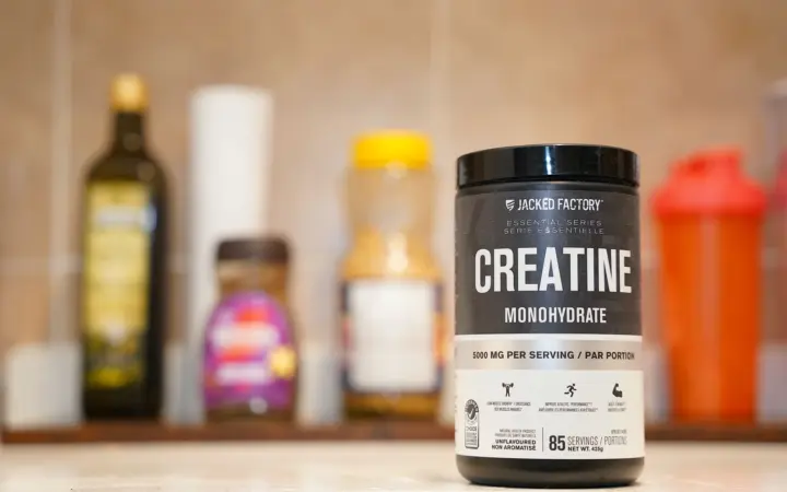 Does creatine cause hair loss: creatine monohydrate from Jacked Factory displayed on a kitchen counter