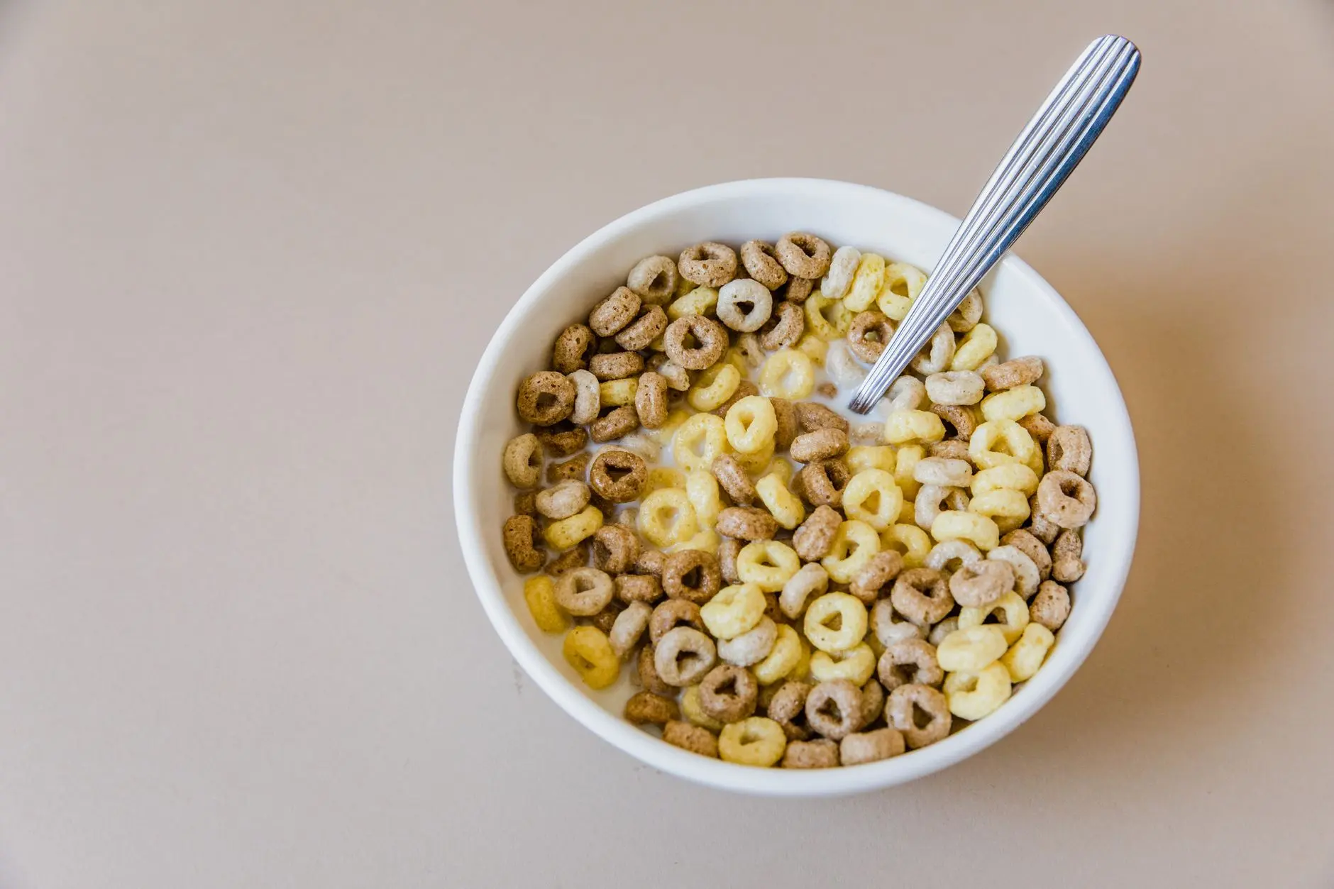 Close-up of a bowl of multi-grain cereal with milk, offering a tasty and healthy breakfast option