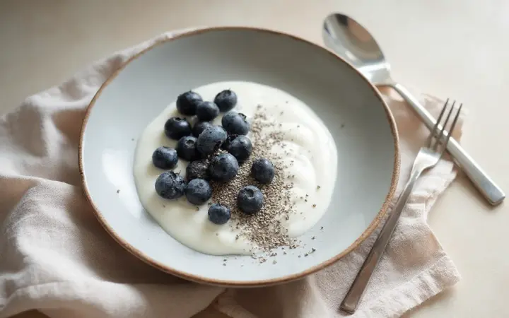 Generated illustration of soy yoghurt with chia and blueberries, not a photograph of the dish