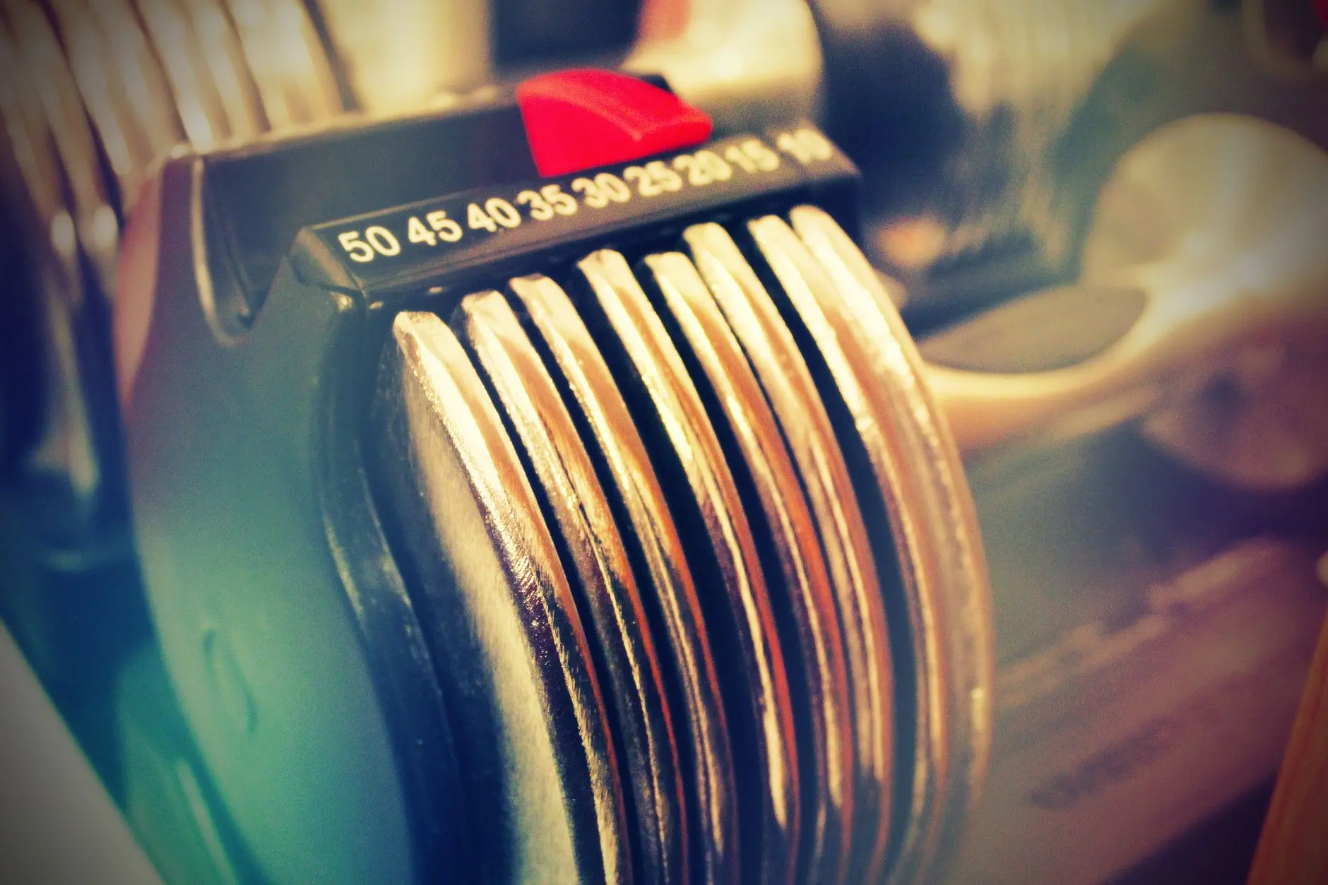 Close-up of adjustable dumbbells with bright lighting, perfect for fitness enthusiasts
