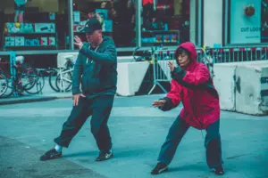 What is tai chi walking for weight loss: two adults practicing martial arts on the street, showcasing fitness and focus in