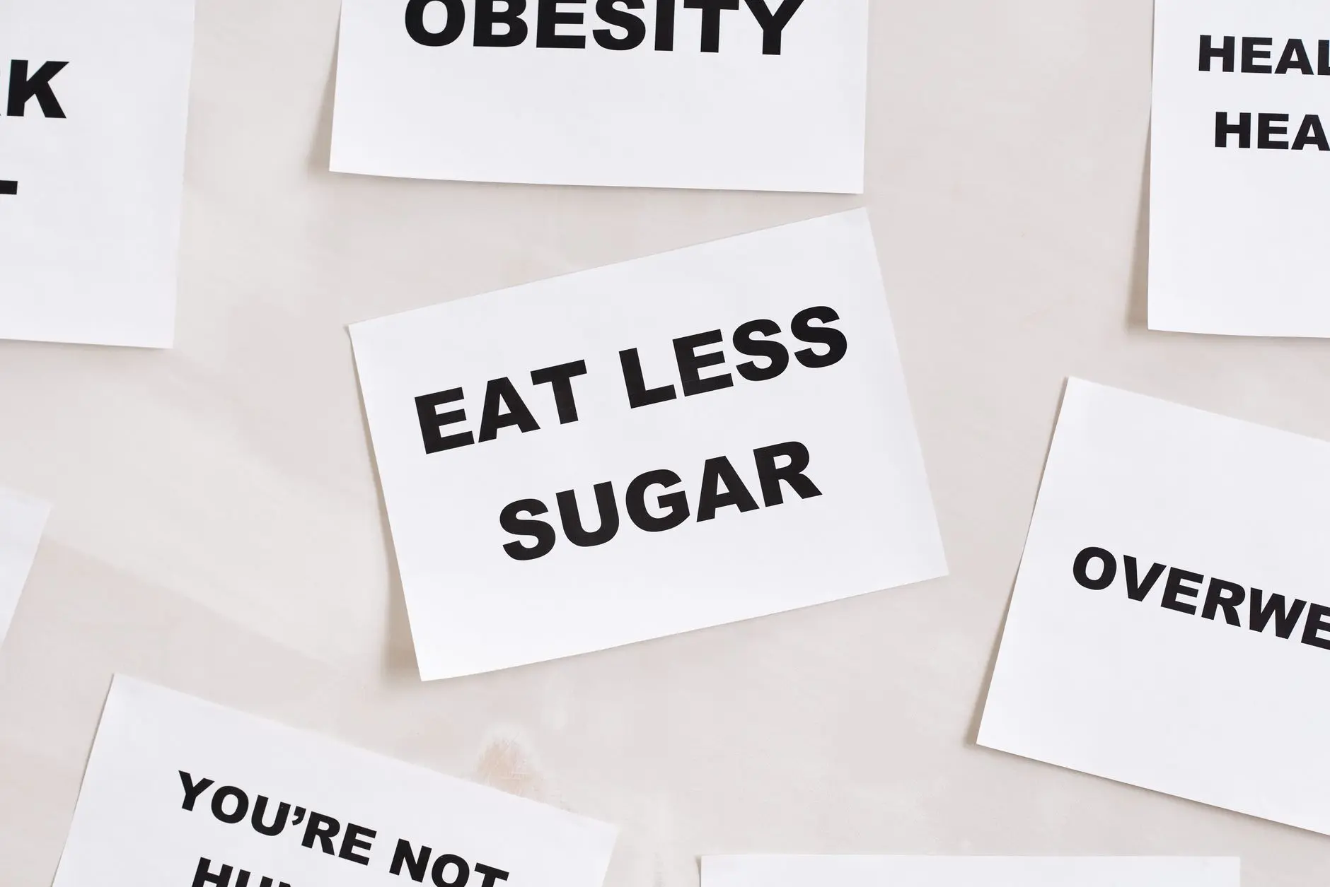 Minimalist photograph of motivational cards with healthy lifestyle messages on a white background