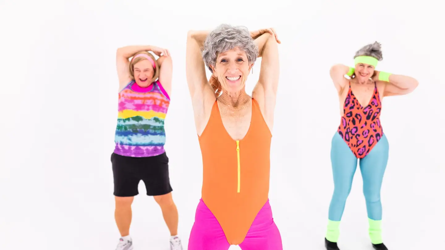 Strength training exercises for women over 60: senior women in vibrant activewear enjoying an aerobic exercise session with