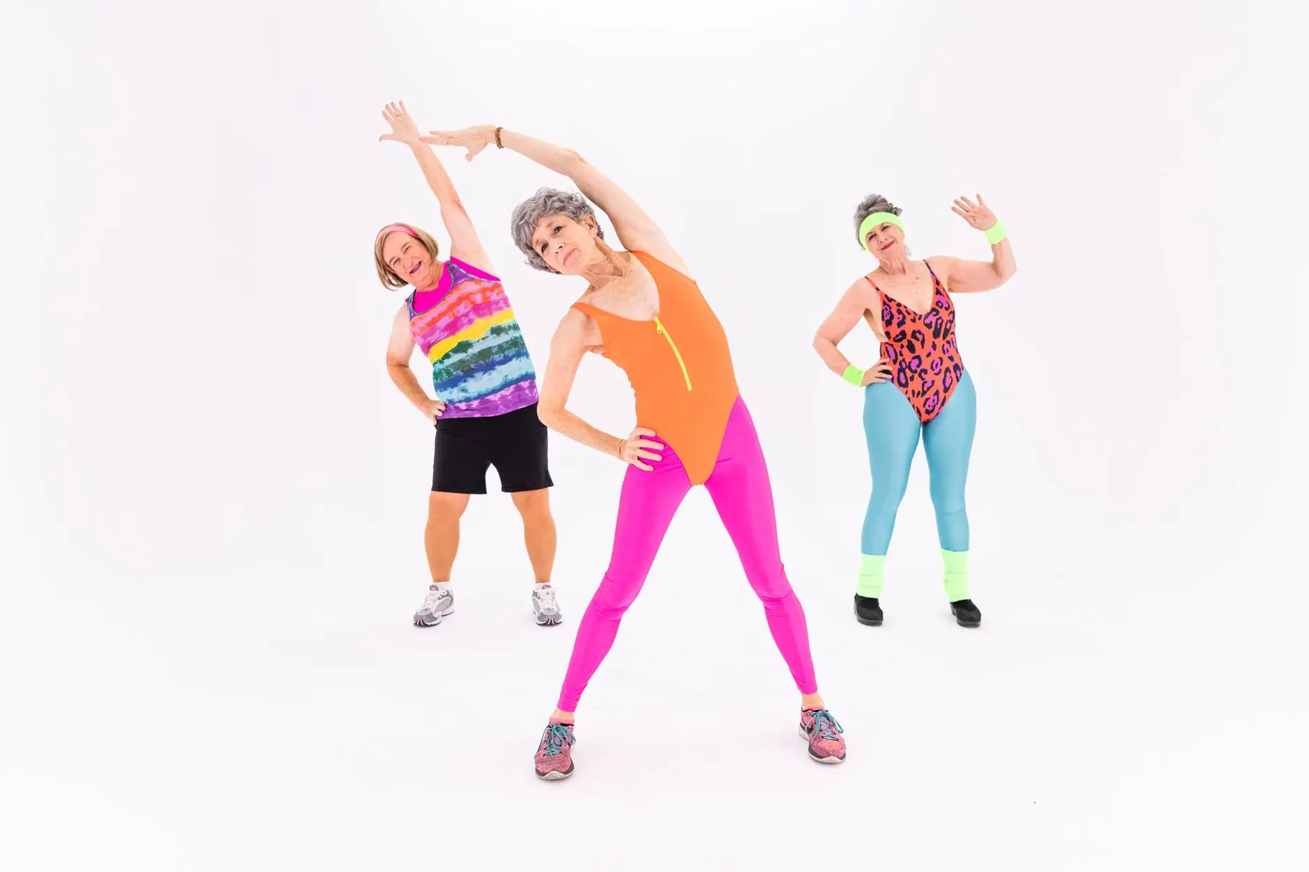 Energetic senior women engaging in fitness with colorful workout outfits, promoting health and joy