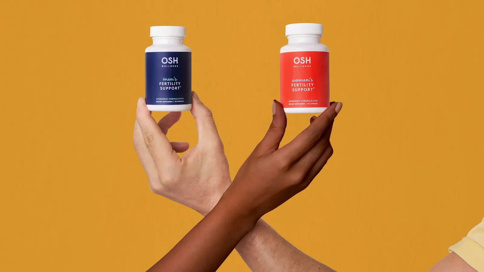 A woman holding two bottles of vitamins in her hands